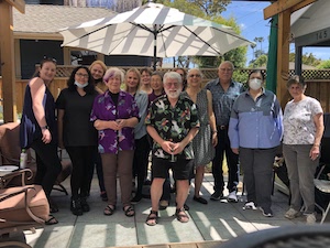 Michelle (in purple) and retirement party attendees